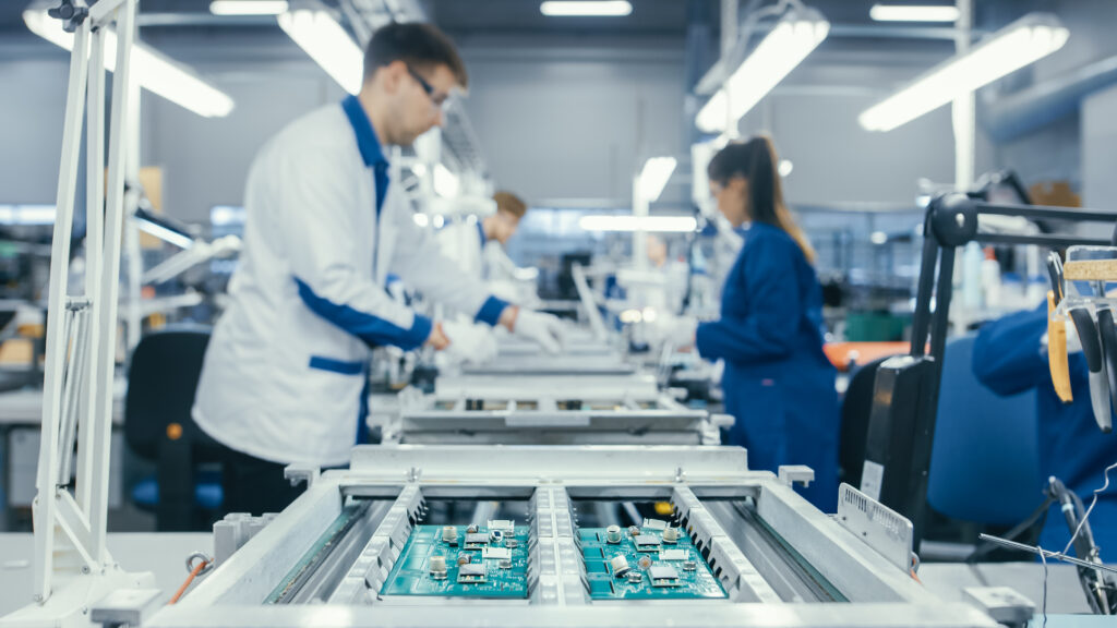 Technicians in Blue and White Lab Coats Conducting a Step-By-Step Guide to PCB Production