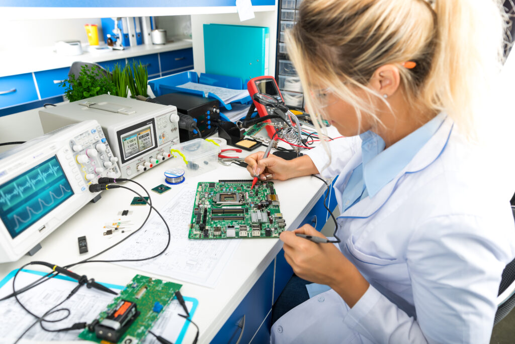 A Technician in White Lab Coat Demonstrating Why Are Circuit Boards Essential in Electronics